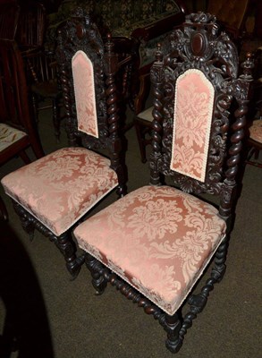 Lot 598 - A pair of Carolean style carved oak hall chairs