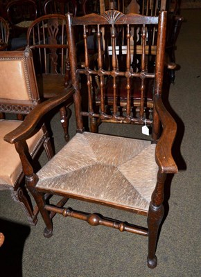 Lot 605 - A 19th century oak country chair, the turned stick back over a rush seat