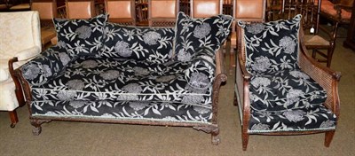 Lot 606 - An early 20th century mahogany bergere settee and a single armchair