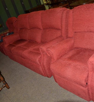 Lot 615 - Red upholstered three piece suite with reclining armchair (3)