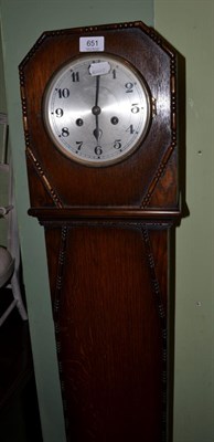 Lot 651 - A 1920's oak veneered striking small longcase clock