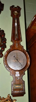 Lot 657 - Mother of pearl inlaid rosewood wheel barometer