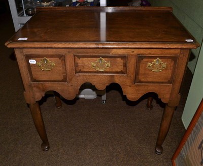 Lot 666 - A George II style oak lowboy