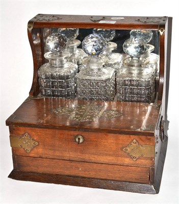 Lot 27 - Oak tantalus with matched decanters