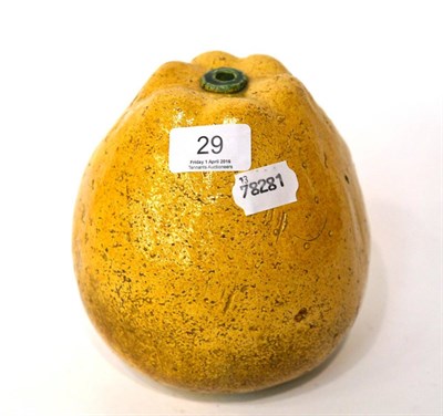 Lot 29 - A Chinese yellow and green glazed pottery model of a fruit, Qing dynasty