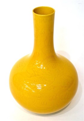 Lot 43 - A Chinese yellow glazed bottle vase with incised dragon decoration, 29cm high
