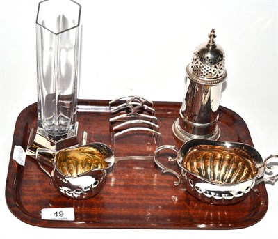 Lot 49 - A silver sugar caster, silver toast rack, twin handled silver sugar bowl, silver milk jug and a...