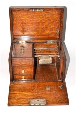 Lot 57 - An oak smoker's compendium with silver plated fittings