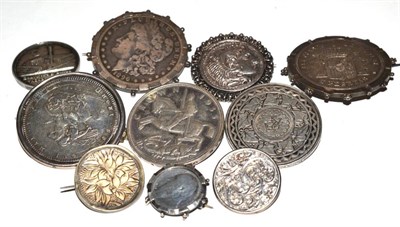 Lot 93 - A group of coin mounted brooches including a George III silver crown, an American one dollar...