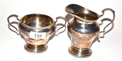 Lot 133 - A silver twin handled sugar bowl together with a matching cream jug