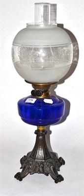 Lot 174 - A Victorian oil lamp with a blue glass reservoir