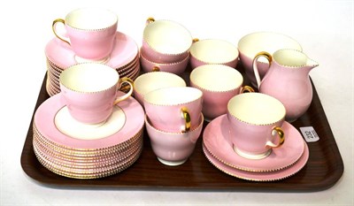 Lot 232 - A Wedgwood pink and gilt highlighted part tea service comprising: ten tea cups, eleven saucers,...