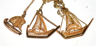 Lot 258 - Three yellow metal filigree boat pendants on chains