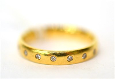 Lot 279 - An 18ct gold and small diamond band