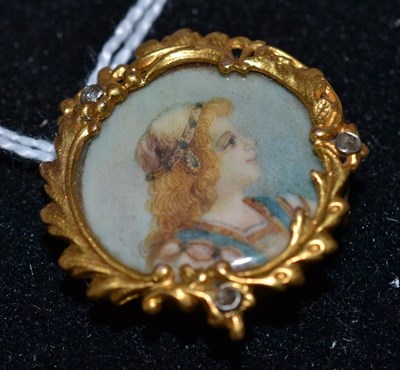 Lot 290 - An Edwardian miniature portrait on ivory in gold and gem set frame, fitted as brooch