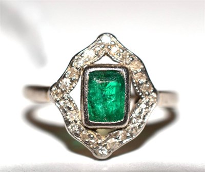 Lot 294 - An emerald and diamond cluster ring stamped '18CT'