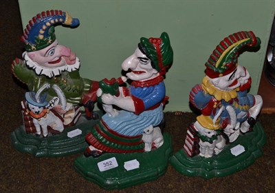 Lot 352 - Three cast iron doorstops in the form of Mr Punch