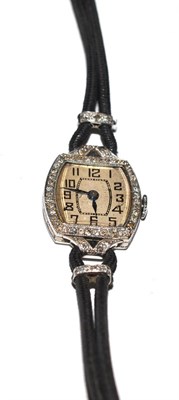 Lot 421 - A lady's diamond set tonneau shaped wristwatch