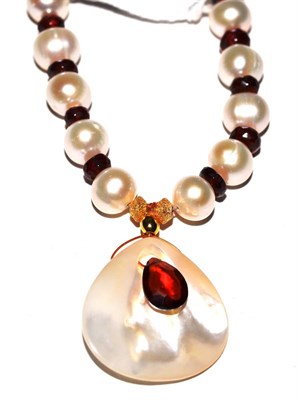 Lot 422 - A garnet and cultured pearl necklace with pendant drop, the cultured pearls spaced with faceted...