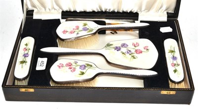 Lot 452 - An enamel backed silver mounted cased dressing table set decorated with flowers, marked for...