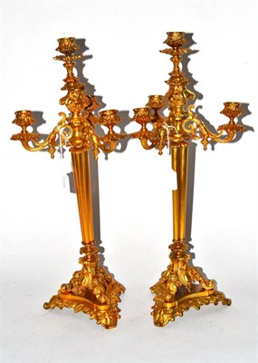 Lot 485 - A gilt metal pair of four light candelabra