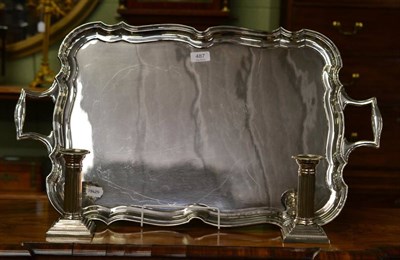 Lot 487 - A plated two handled tray by Goldsmiths & Silversmiths and a pair of plated pillar candlesticks