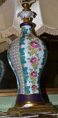 Lot 493 - A floral painted porcelain table lamp