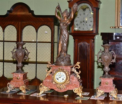 Lot 499 - A French style gilt metal mounted rose marble clock garniture, the clock surmounted by a...