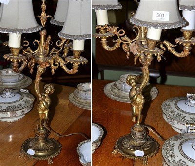 Lot 501 - A pair of gilt metal four light figural table lamps in the form of putti (one a.f.)