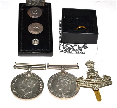 Lot 524 - A 22ct gold ring, two Second World War medals, Yorkshire Regt cap badge and a belt clip set...