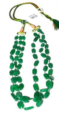 Lot 536 - An Indian emerald necklace on silk cord (treated)