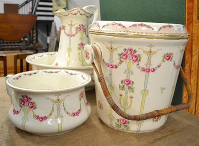 Lot 1037 - A Losol ware toilet set including wash jug and bowl etc, decorated with floral sprays and swags (4)