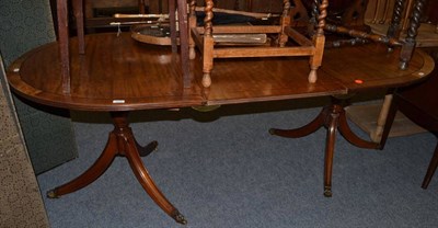 Lot 1070 - A twin pedestal Regency style dining table