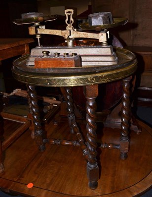 Lot 1071 - A brass tray top table, circular brass tray, two copper items, set of scales and two sets of...