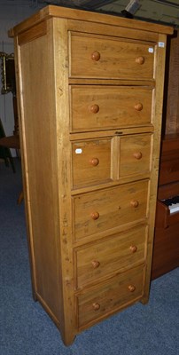 Lot 1083 - A modern oak tallboy fitted with a dressing slide