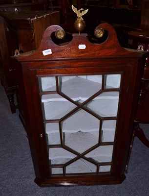 Lot 1096 - A mahogany corner cupboard with swan neck pediment