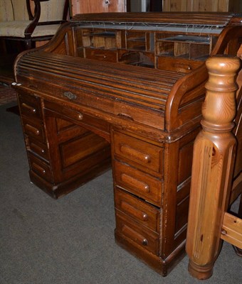 Lot 1262 - A 1920's oak roll top desk