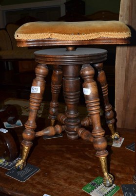 Lot 1272 - An adjustable piano stool with brass and glass claw feet