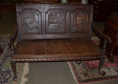 Lot 1293 - An 18th/19th century carved oak settle