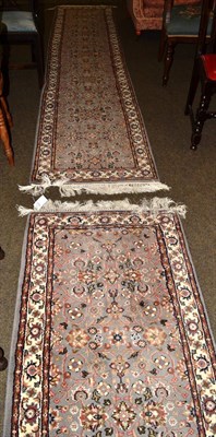 Lot 1316 - A 'matched' pair of narrow Indian runners, each with a dove grey Herati field enclosed by...