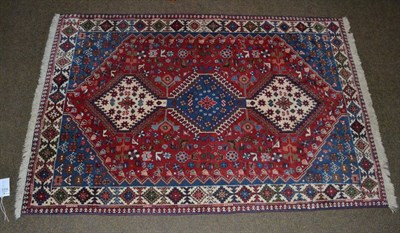 Lot 1318 - Yalameh rug, the crimson field with three central latch hook medallions framed by spandrels and...