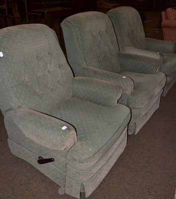 Lot 1333 - A set of three armchairs upholstered in green, including one recliner