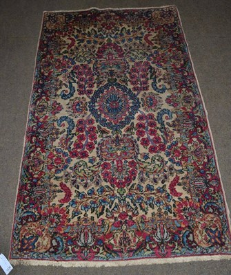 Lot 1336 - Kirwan rug, South East Persia, the ivory field of flowering plants centred by a pale indigo...