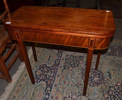 Lot 1342 - A late George III mahogany and inlaid foldover tea table