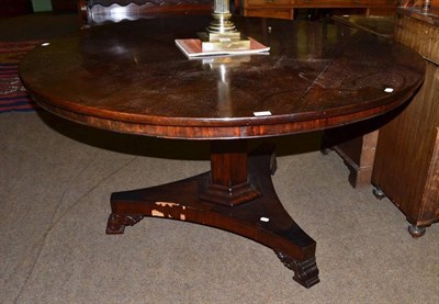 Lot 1348 - A mid 19th century mahogany pedestal table, raised on a waisted tri-form platform base