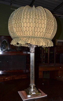 Lot 1349 - A silver plated Corinthian column lamp with a large fabric shade (plating heavily worn)