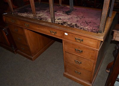 Lot 1356 - An early 20th century oak leather inset twin pedestal desk