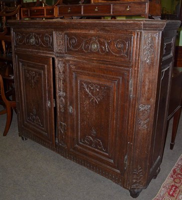 Lot 1362 - A carved oak two door cupboard