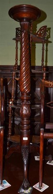 Lot 1365 - A 19th century mahogany torchere raised on ball and claw feet