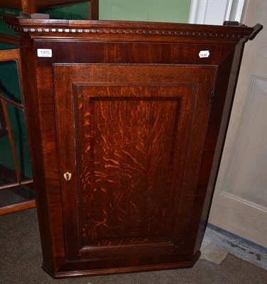 Lot 1370 - A George III oak hanging corner cupboard